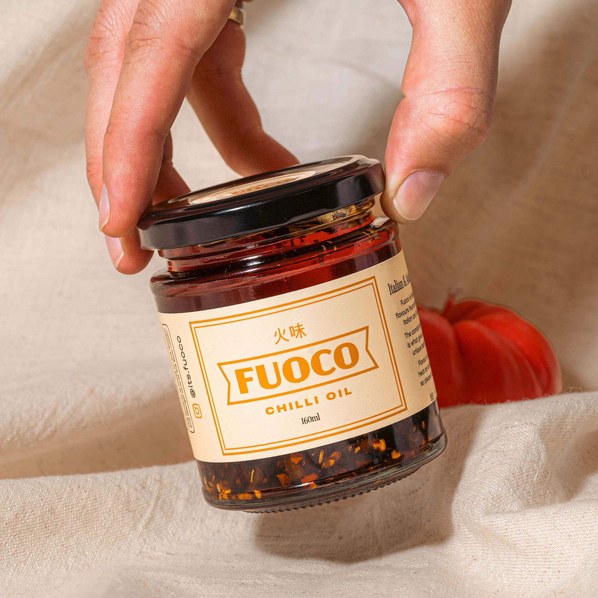 Fuoco crispy chilli oil 190ml hand holding jar